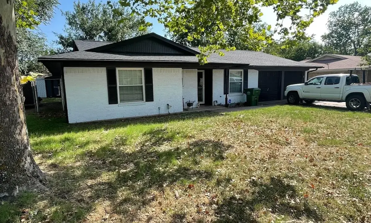 Professional roofing crew working on a residential roof in Metuchen